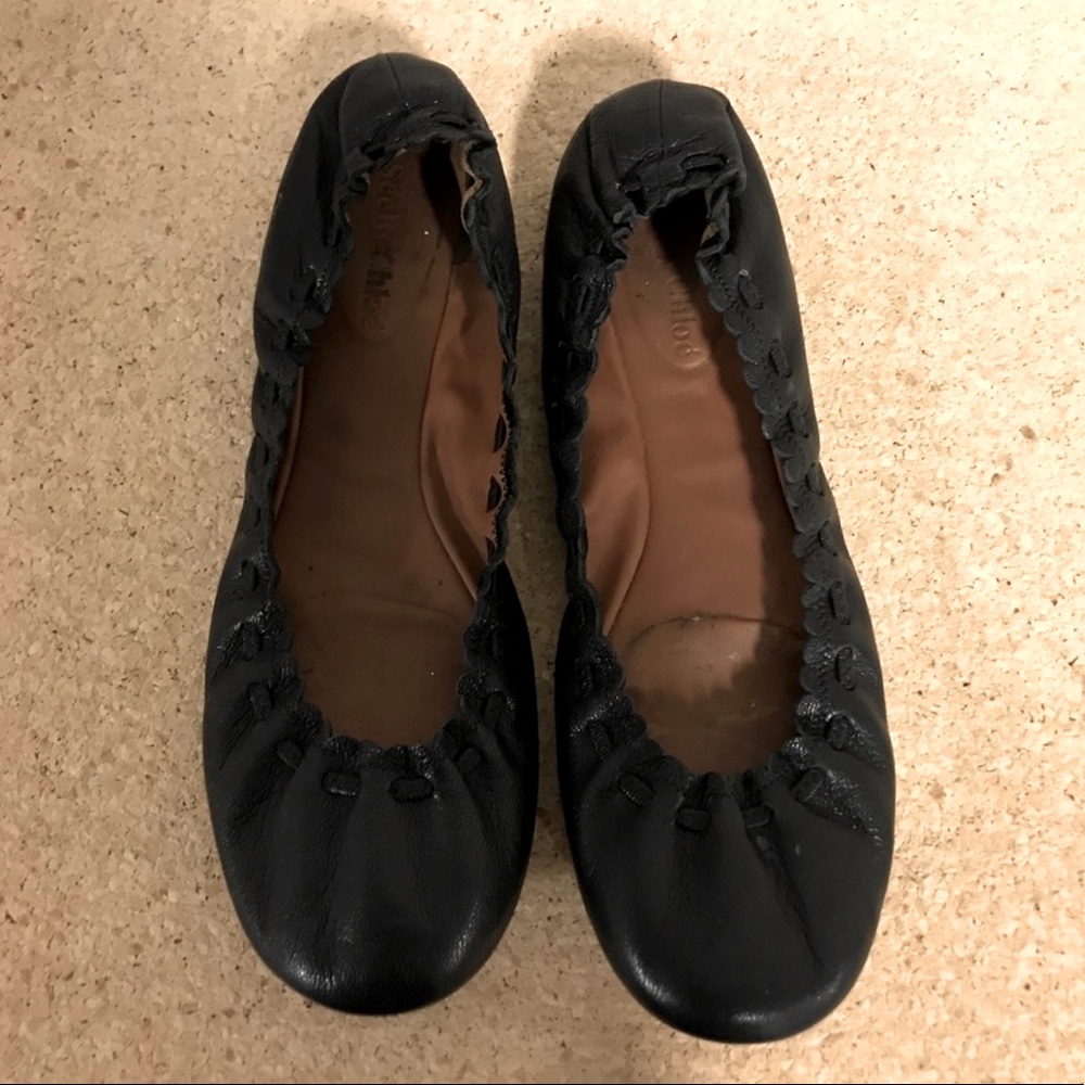 Black leather “See By Choé” flats.